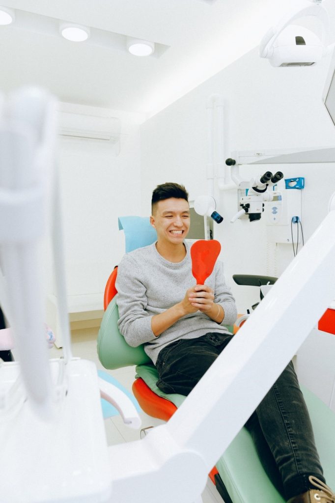 A young man smiling while at the dentist’s