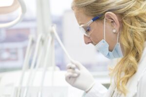 Female Dentist attending to patient