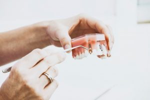 Dentist showing off a denture
