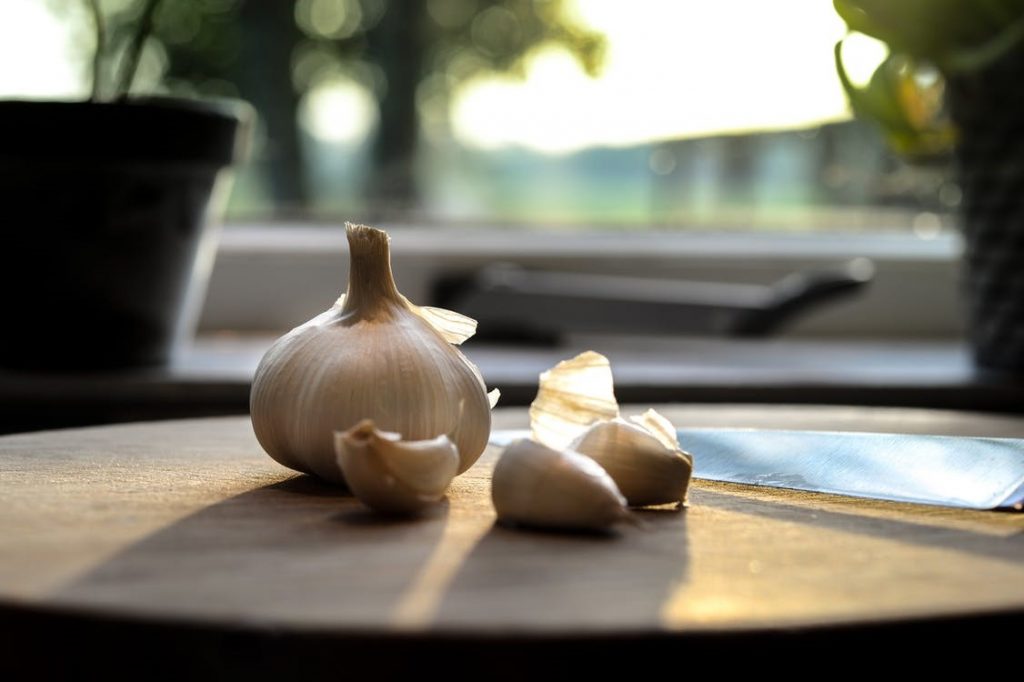 Garlic cloves placed on a wooden table 