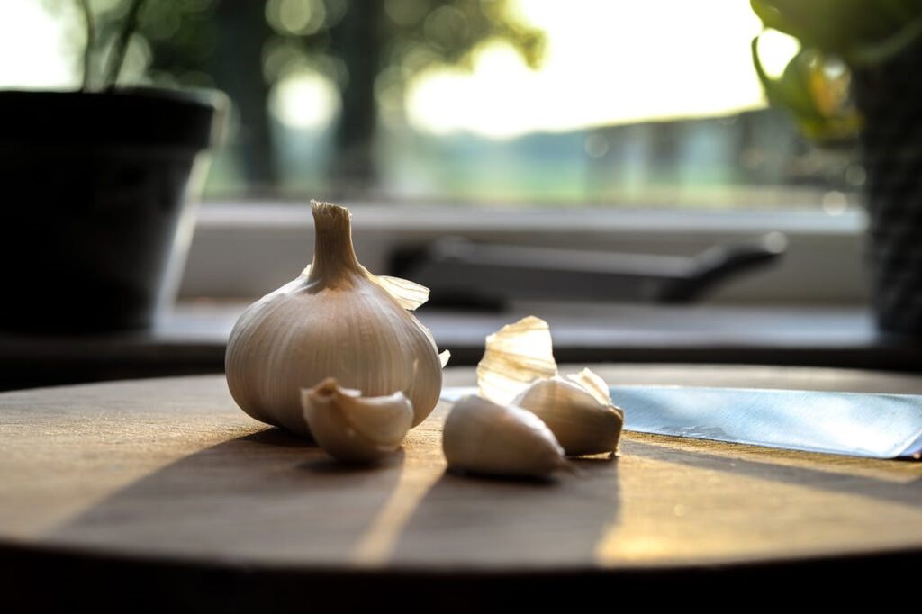 Garlic cloves placed on a wooden table 