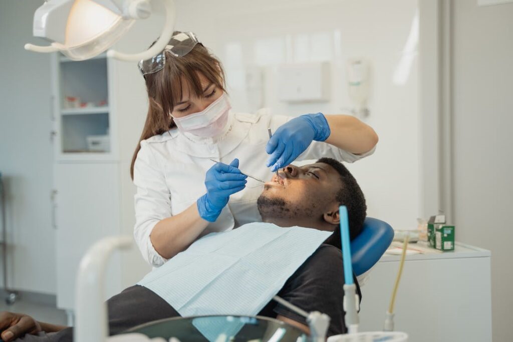 A dentist is treating the patient using a sedation technique.