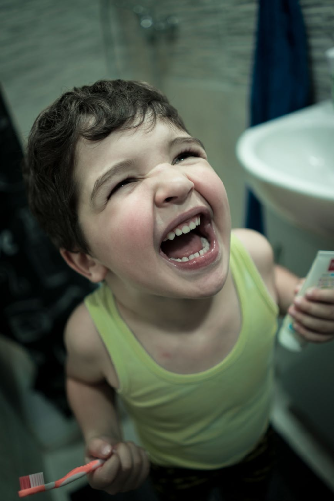 Excited child holding a toothbrush