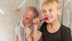 A man and a child brushing their teeth
