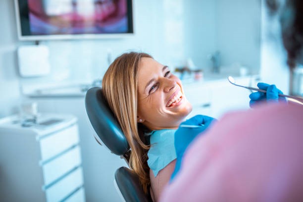 Woman smiling while getting dental treatment in Calabasas