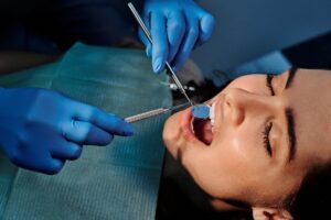 A dentist checking a patient’s teeth