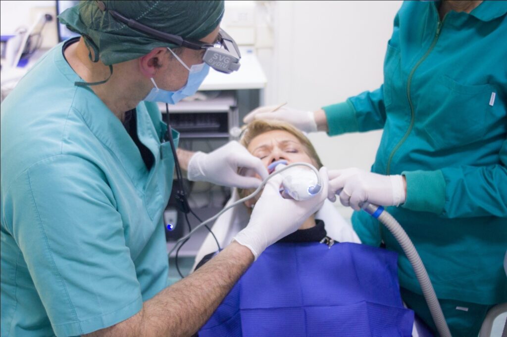 Dental care professionals performing a treatment on a child
