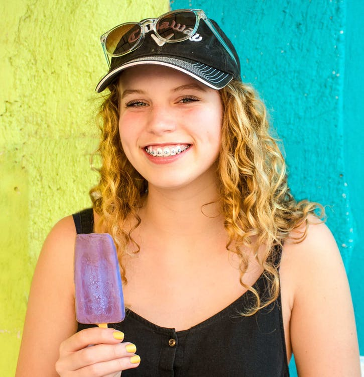 A woman with ice cream and braces.