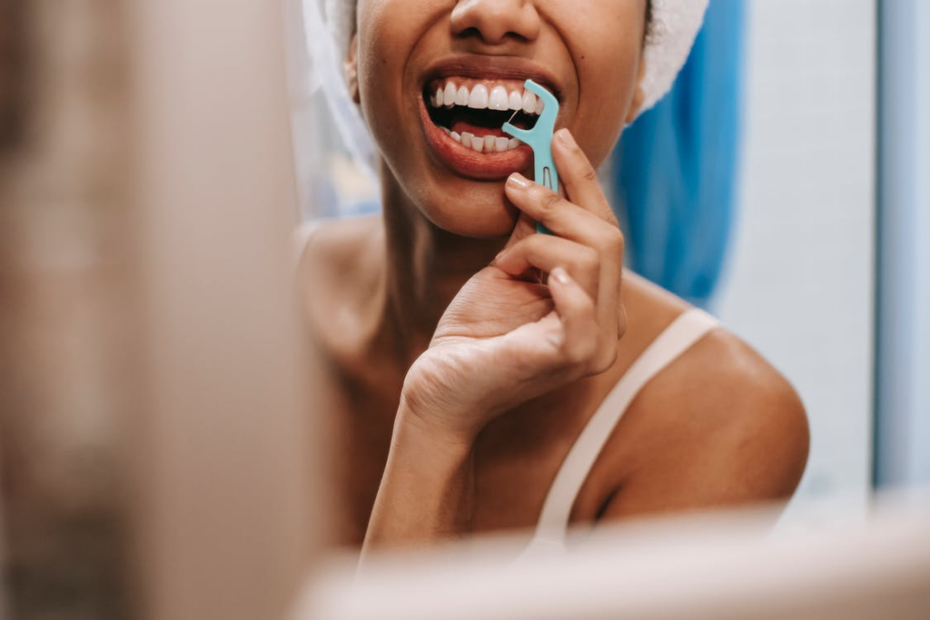 Woman flossing her teeth