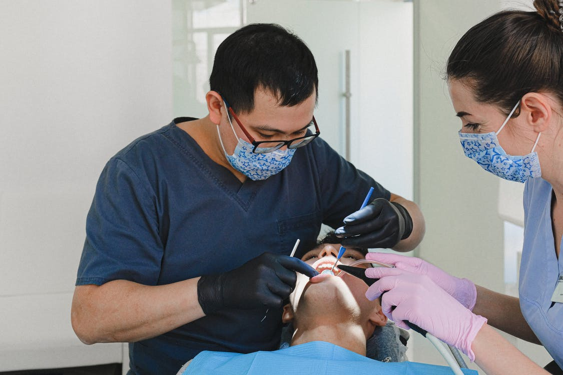 A dentist is performing a dental treatment.