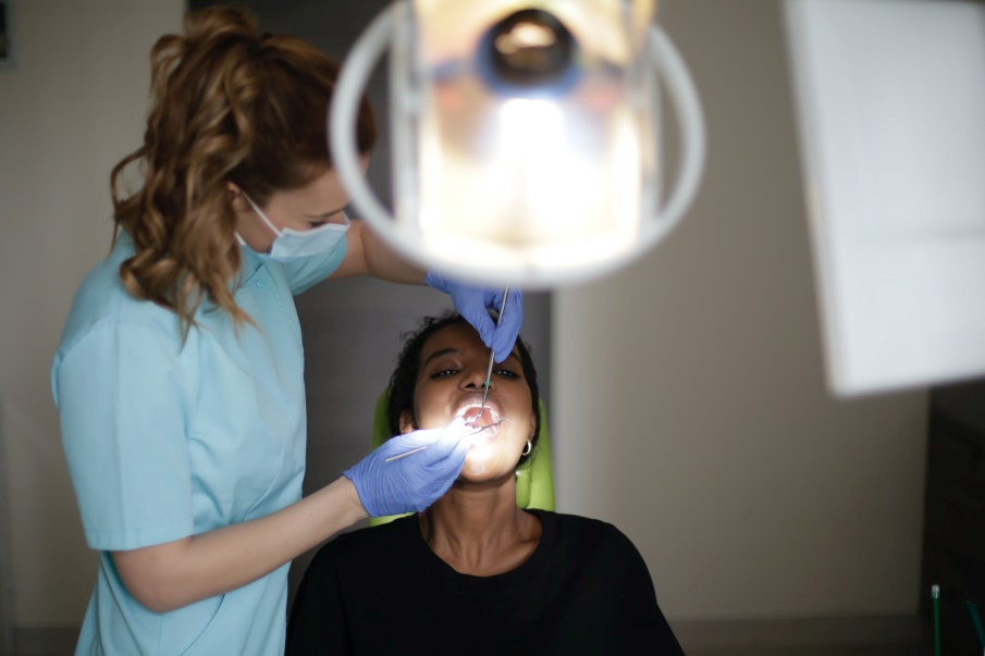 A dentist performing a checkup with patient