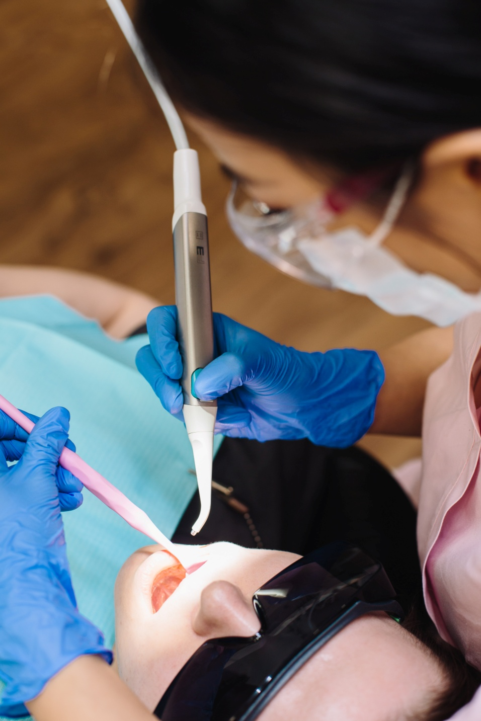 A dentist inspecting the teeth of a patient in a dental clinic in West Hills, CA