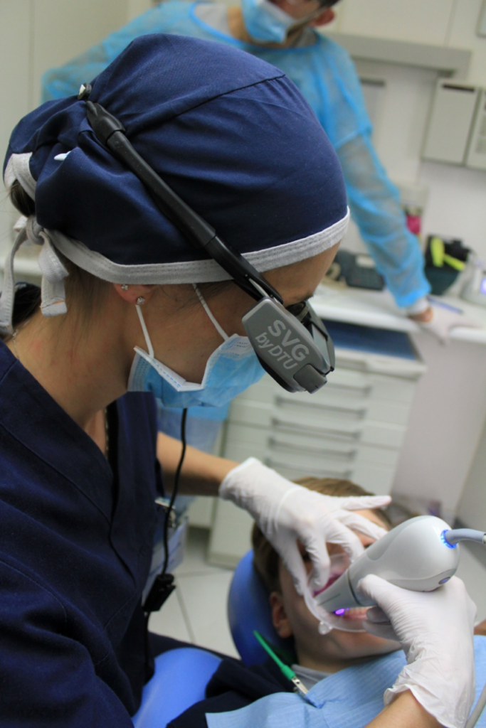 a dentist performing professional teeth whitening