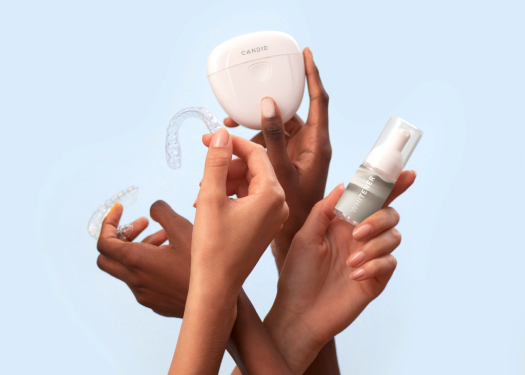  hands holding Invisalign aligners and their container