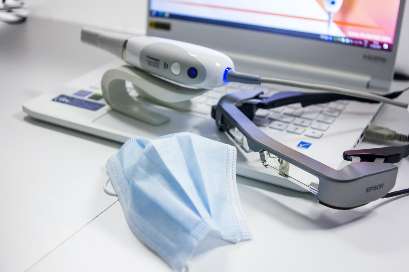laser dentistry equipment placed on top of the laptop