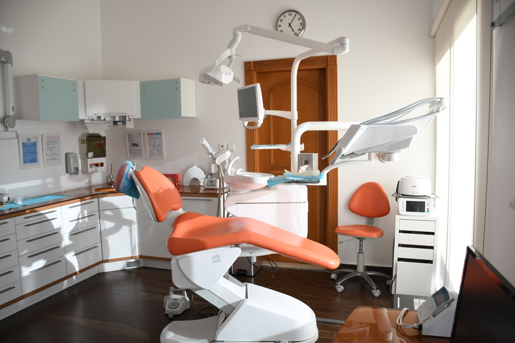 Fully equipped dentist office with orange chair