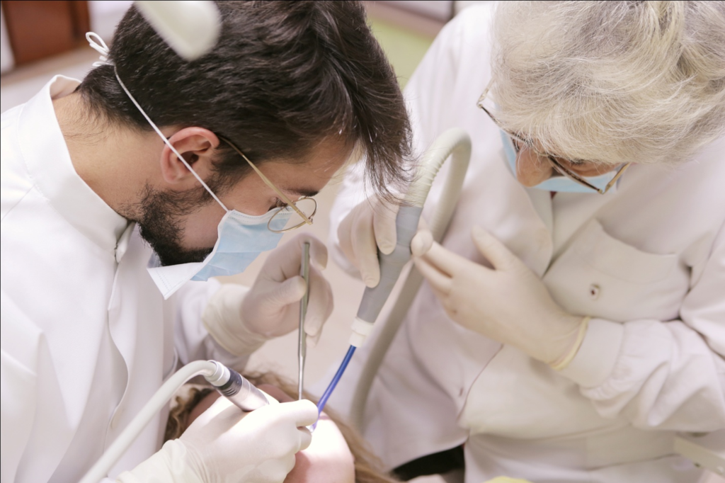 A dentist is using sedation dentistry to treat a woman