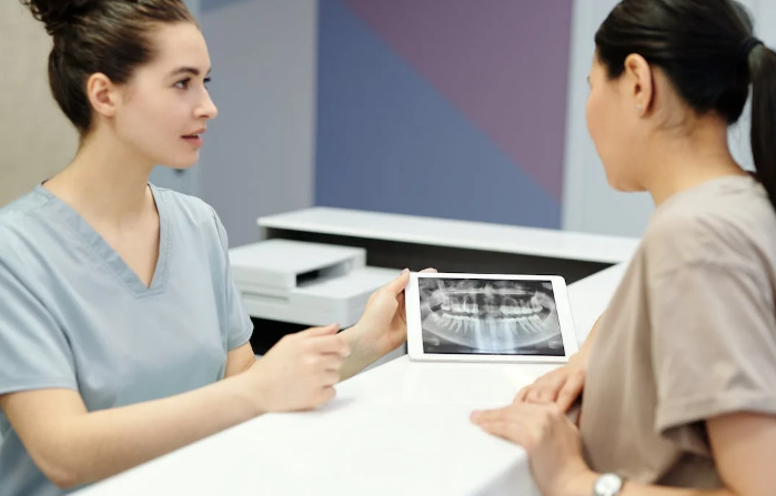 Two hygienists discussing patient X-Ray