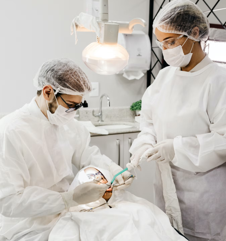 A dentist and his assistant performing on a patient