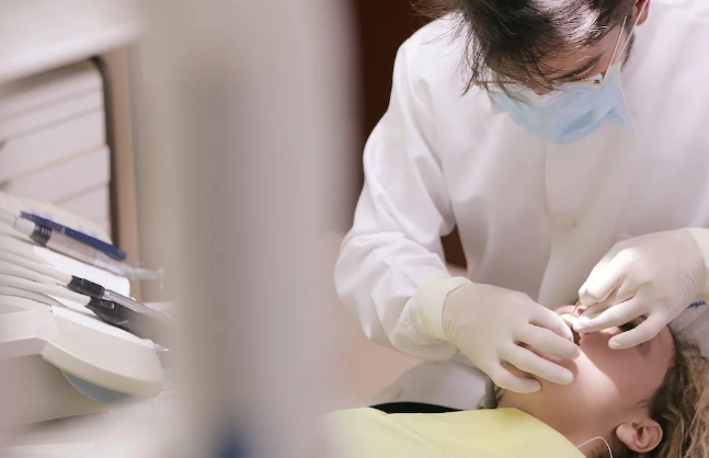 A dentist treating a patient for oral issues