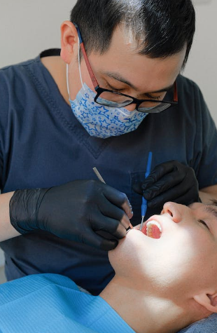 A dentist inspecting a patient's dental health in West Hills, CA