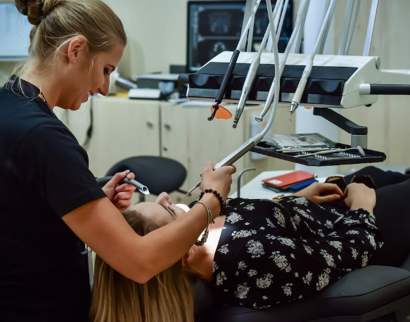 A dentist performing an oral treatment on a patient