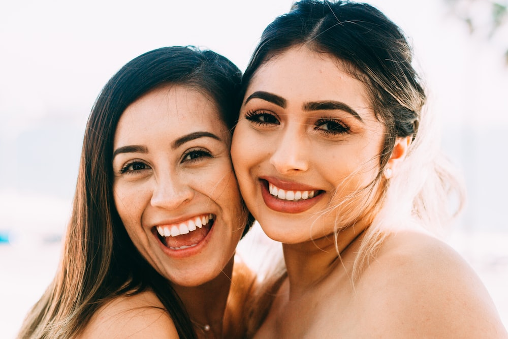 two women smiling widely