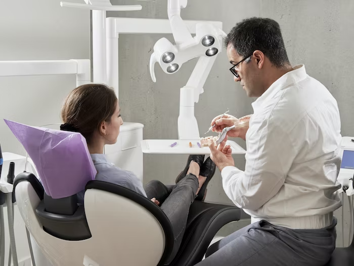 A dentist explaining a surgical procedure to a patient 