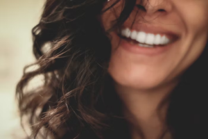 A woman smiling after a professional teeth whitening