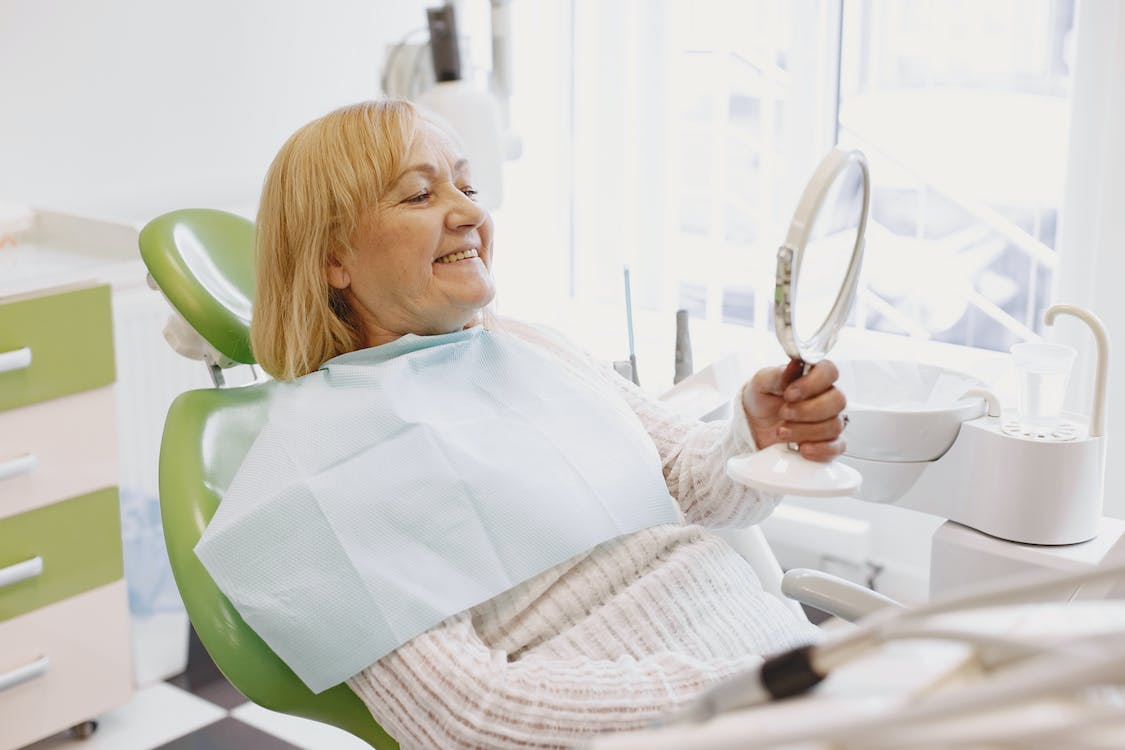 A smiling elderly patient in a dentist’s office