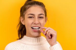 A teenager removing the Invisalign tray