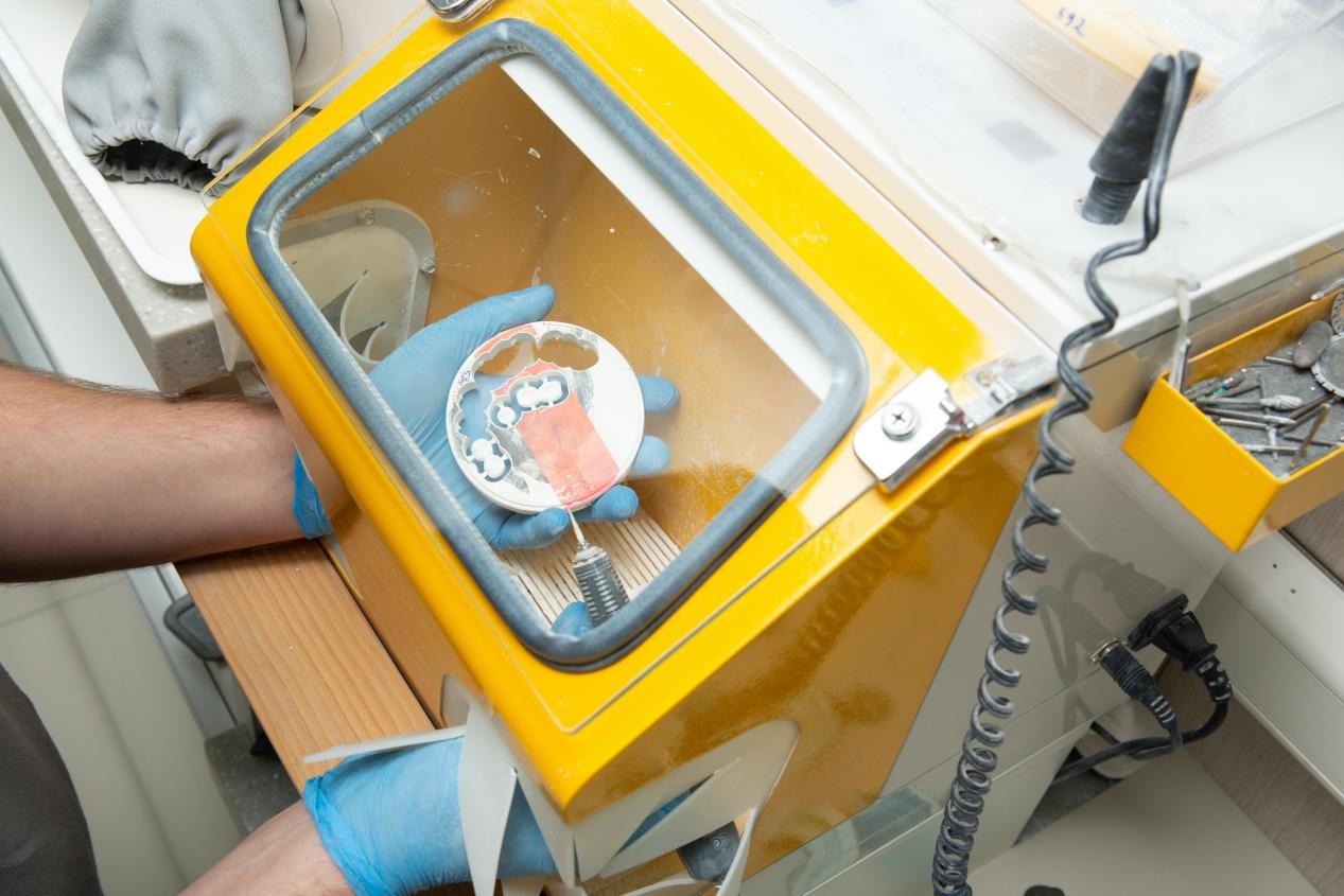 A dentist making artificial teeth