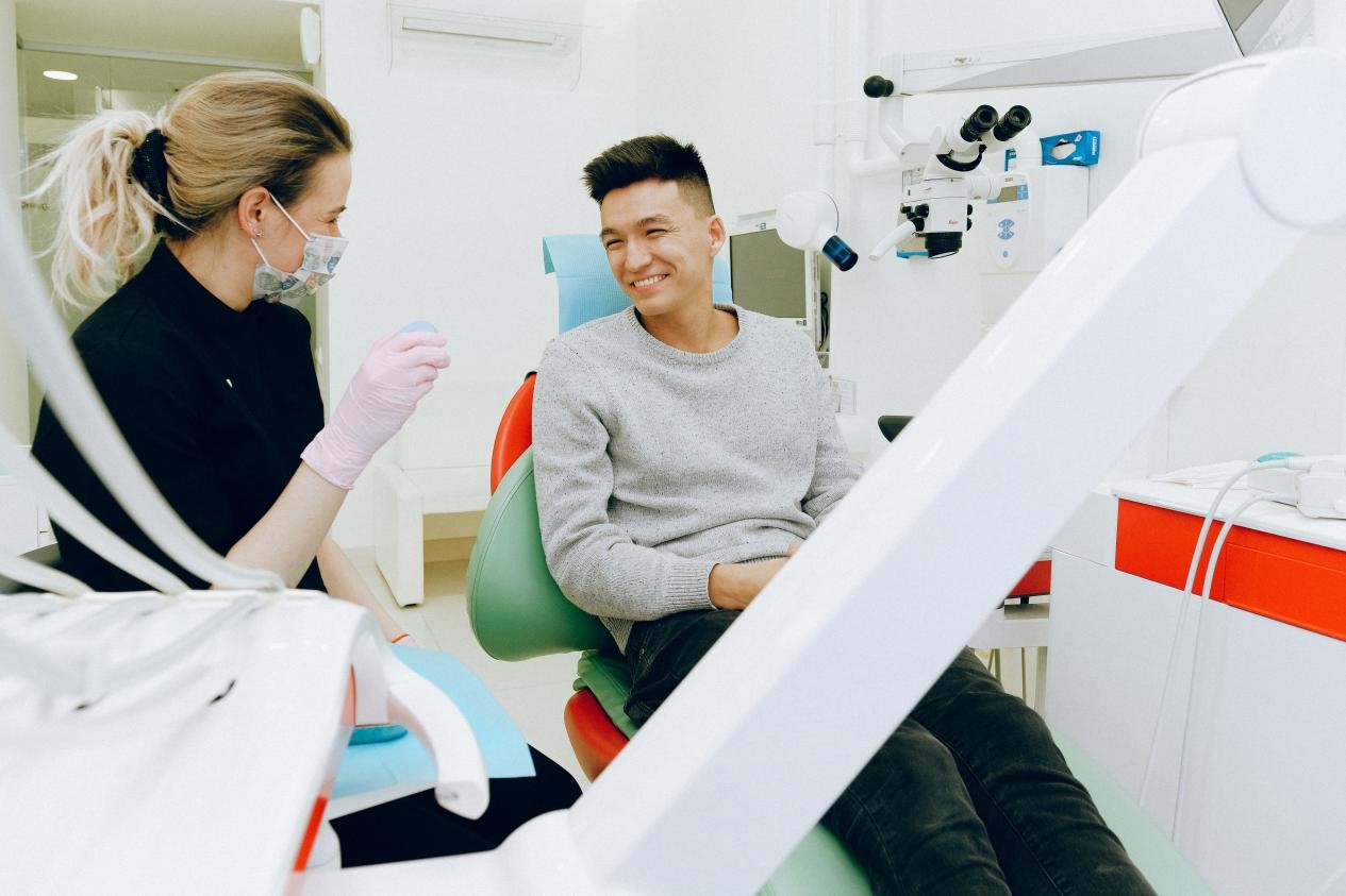 A dentist chatting with her patient