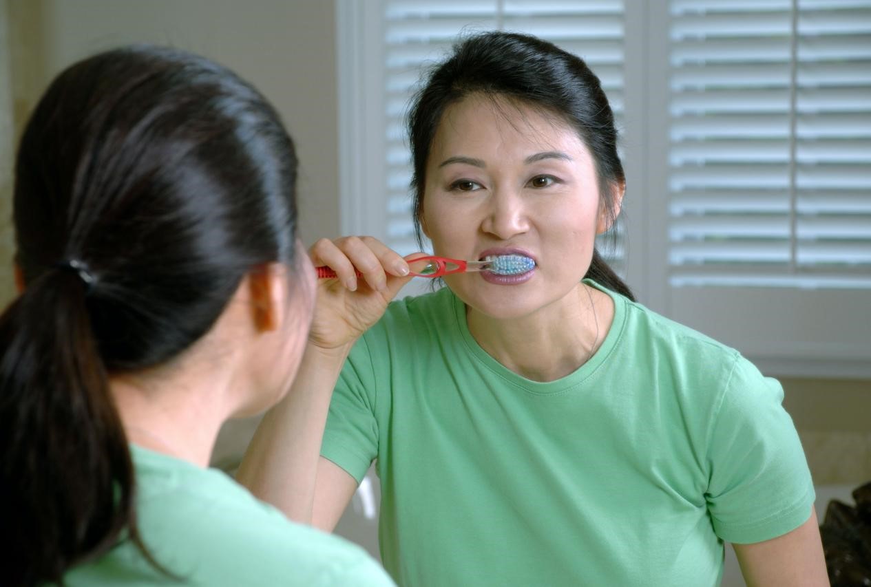 A woman brushing her teeth