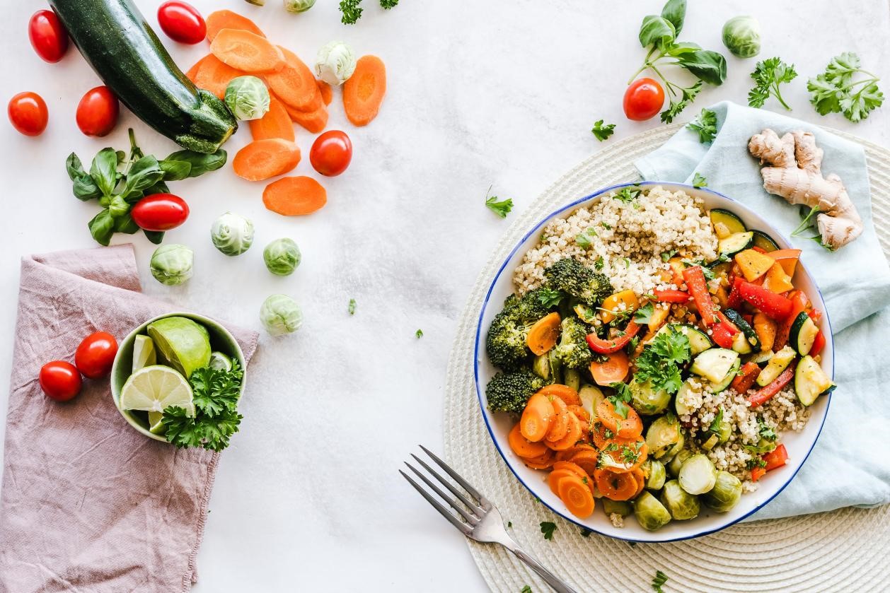 A vegetable salad and a fork on a table