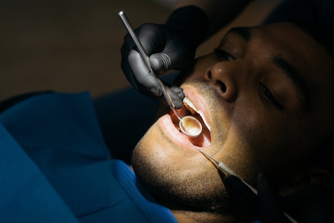 A closeup shot of a man having a dental checkup