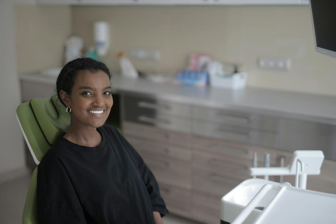 A lady in a dental clinic, smiling