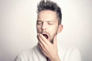 A man covering his mouth with his hand due to a bad breath issue