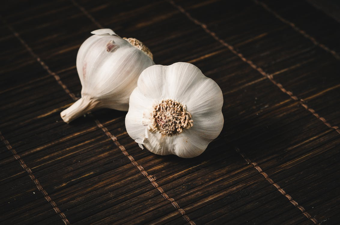 An image showing two white cloves of garlic