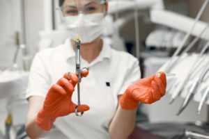 A dentist holding a syringe