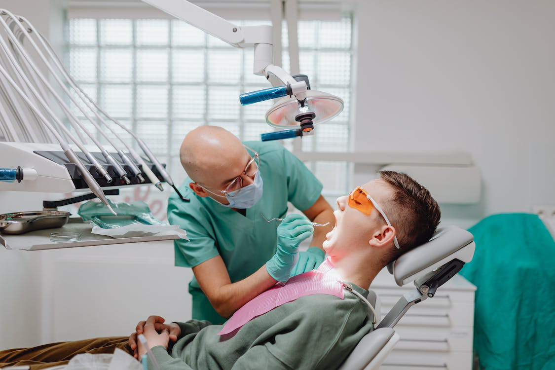 A dentist performing an oral examination